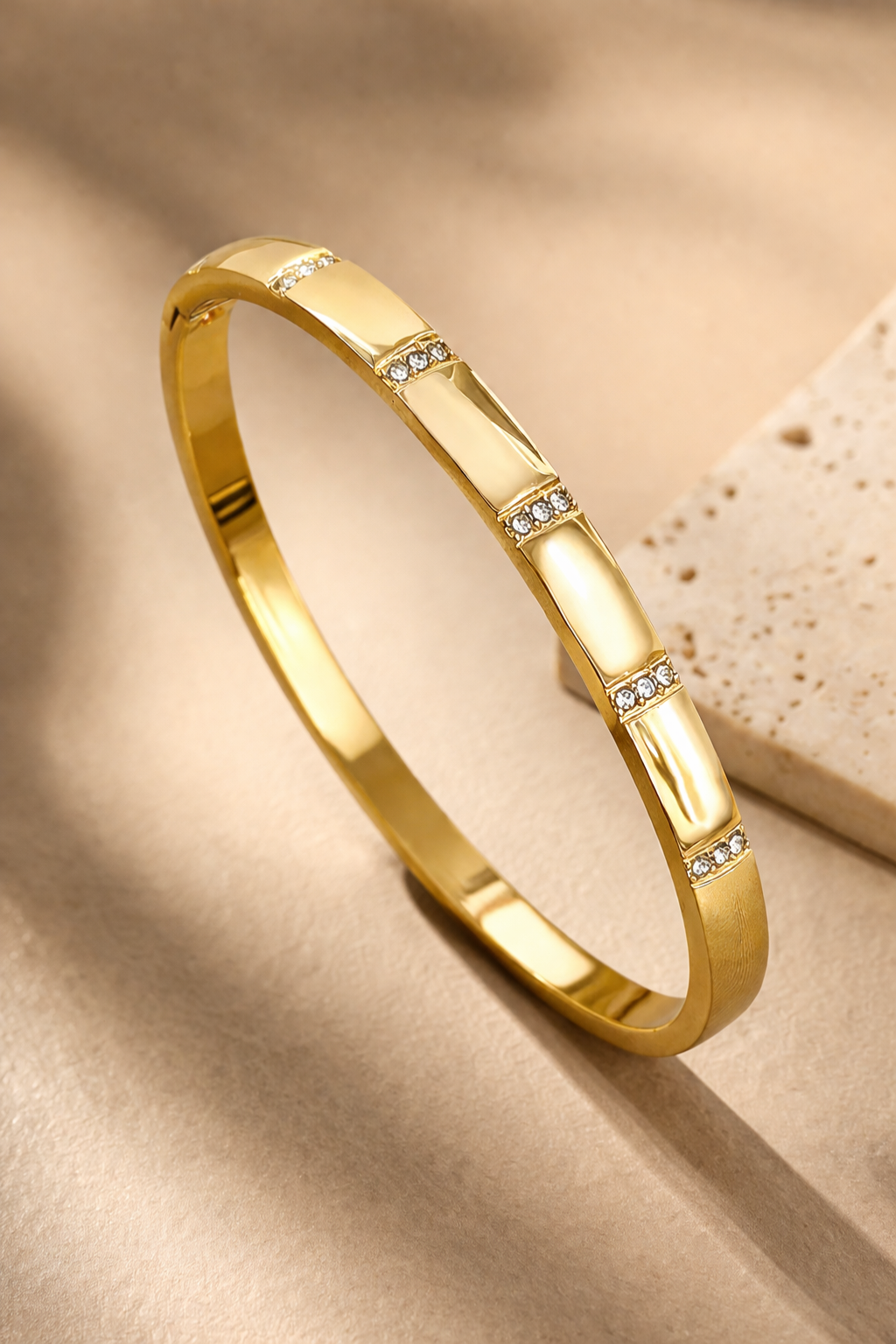 Valdor Orélis gold bracelet with diamond accents worn on wrist, minimalist luxury bangle for women in 18k gold plated stainless steel