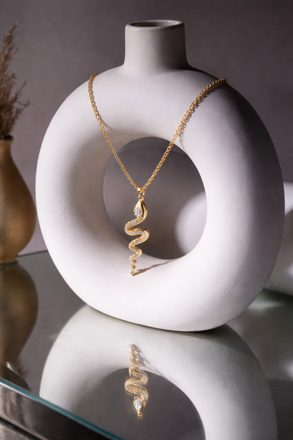 Valdor Ophia snake necklace in gold finish with sparkling zirconia stones, a refined luxury piece inspired by timeless elegance.