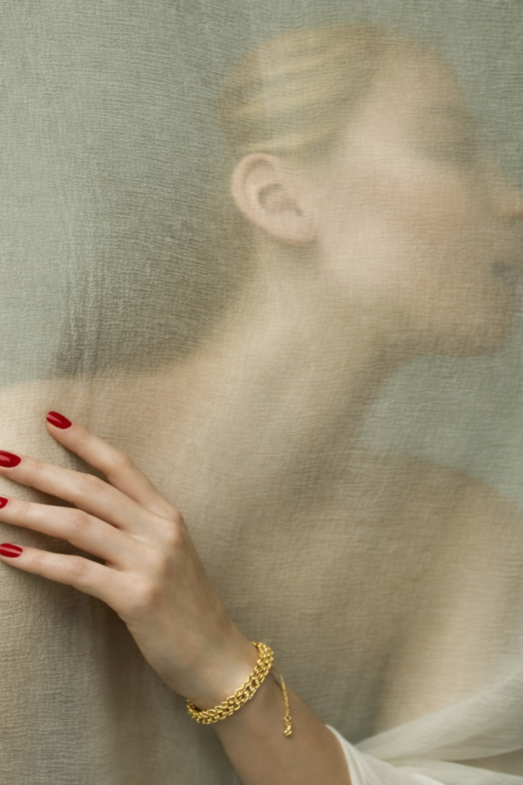 Woman wearing a gold bracelet with a blurred background