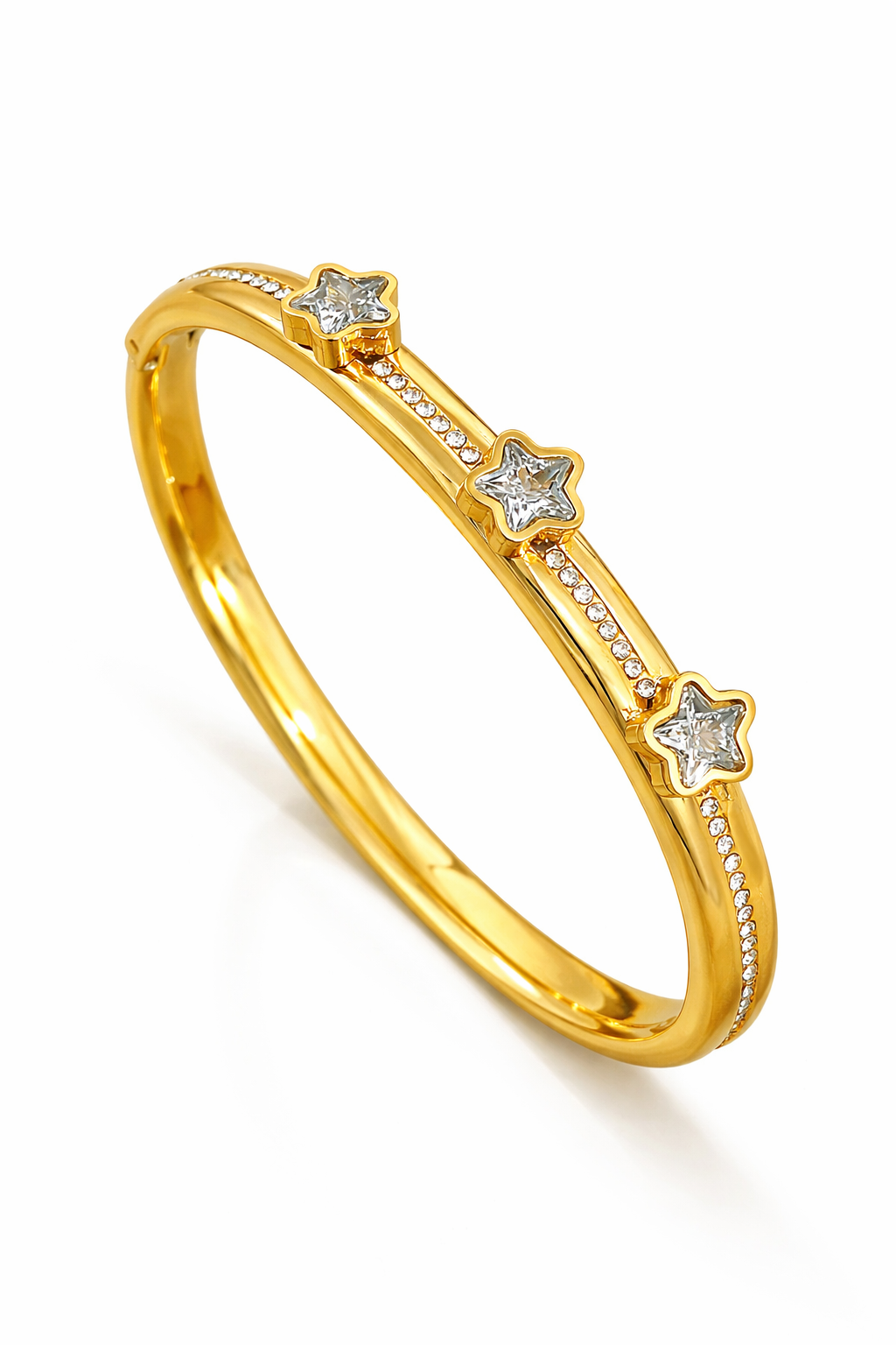 Valdor Astryx star bracelet worn on wrist, gold bangle with zirconia stones in a modern luxury style