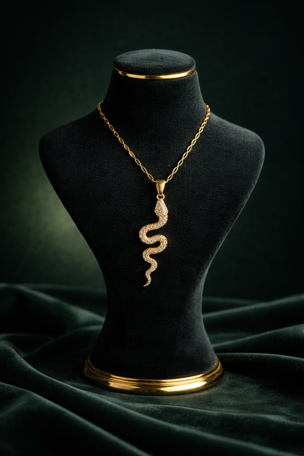 Close-up of the Valdor Ophia snake necklace highlighting precision-set zirconia stones and luminous gold finish.
